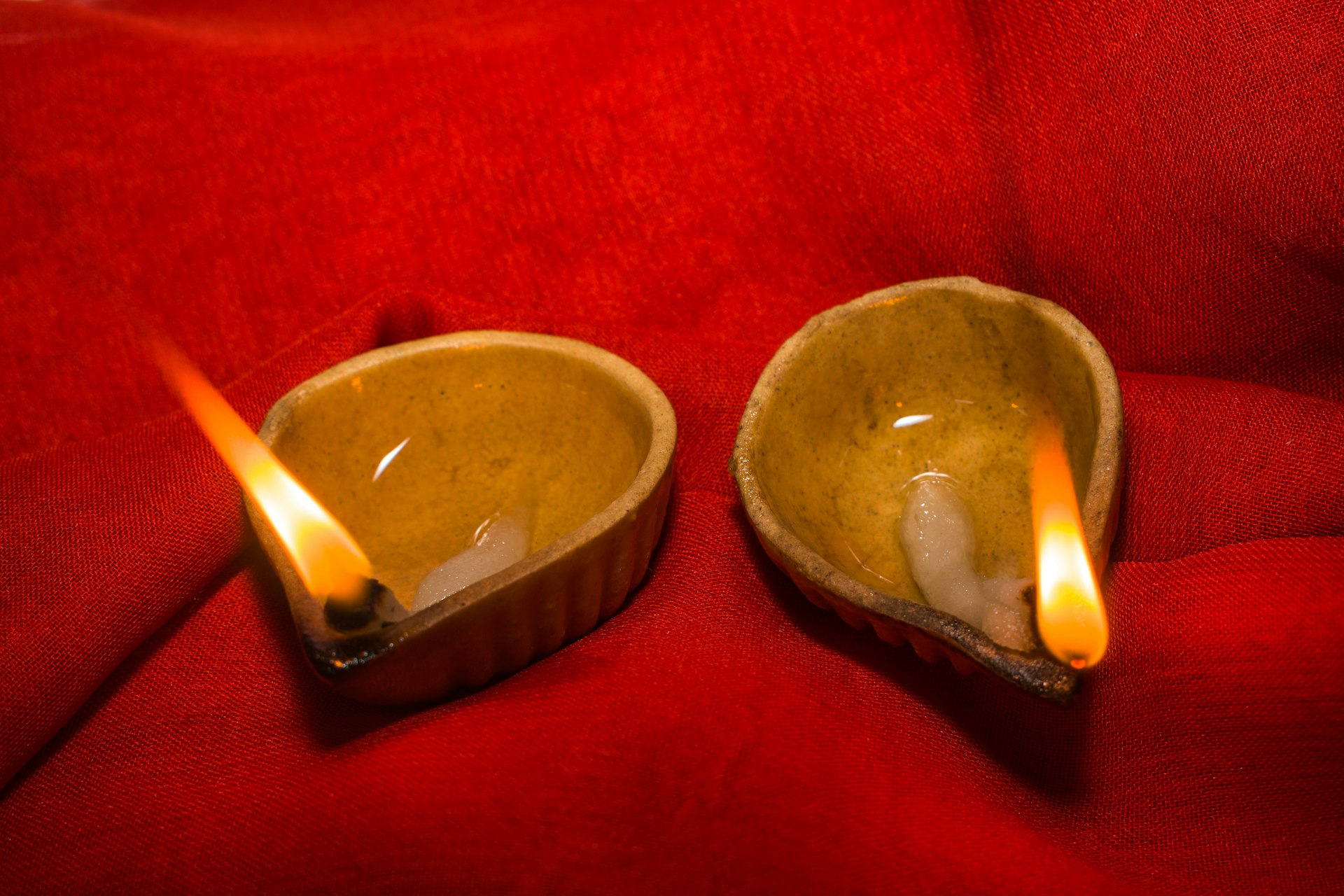 a couple of small bowls sitting on top of a red couch